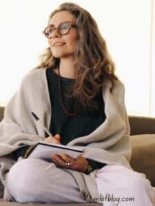 the-image-a-shows-a-lady-jotting-something-in-a-book-with-her-pen