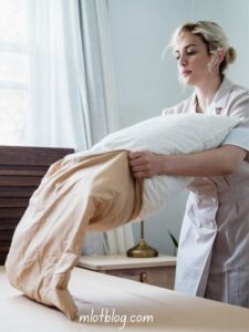 the-image-shows-a-lad-dressing-her-pillow-with-a Silk-or-Satin-Hair-Wrap-or-Pillowcase